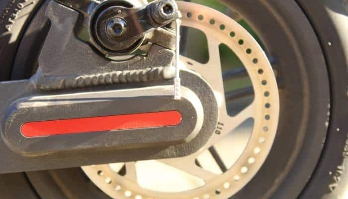 How do I adjust the brakes on my electric scooter?